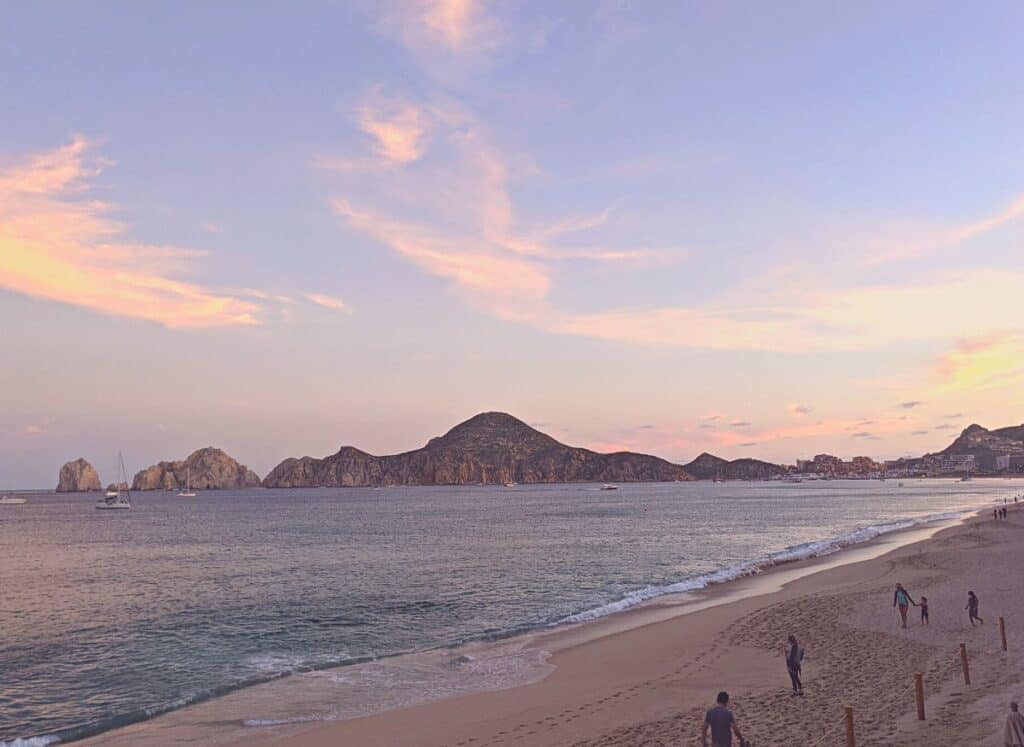 Sunset over the the famous rocky Cabo San Lucas coast line.