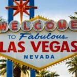 The famous "Welcome to Fabulous Las Vegas Nevada" sign with palm trees and clear sky in the background is one of the top free things to do in Las Vegas.