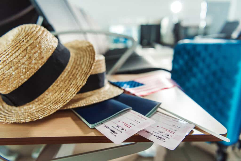 Passports and a hat on a table ready for travel.