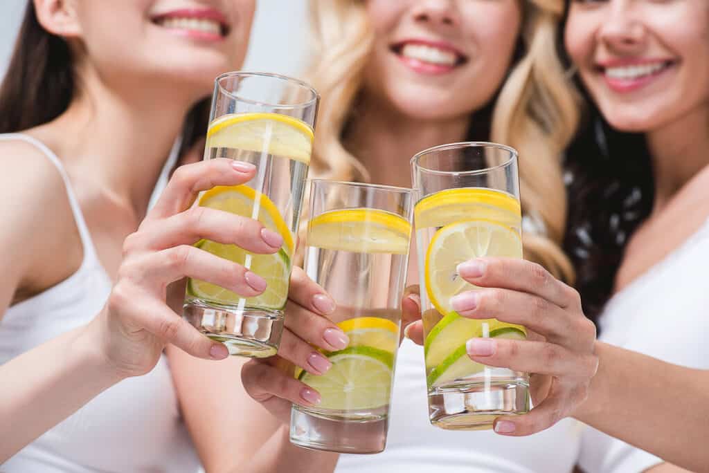 Three women drinking lemon water.