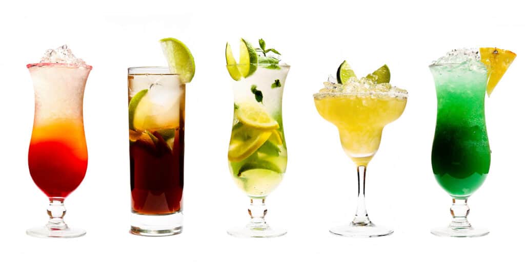 5 different cocktails in various glasses on a white background.