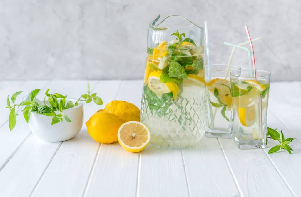 Cut lemons in water in glasses and in a pitcher.