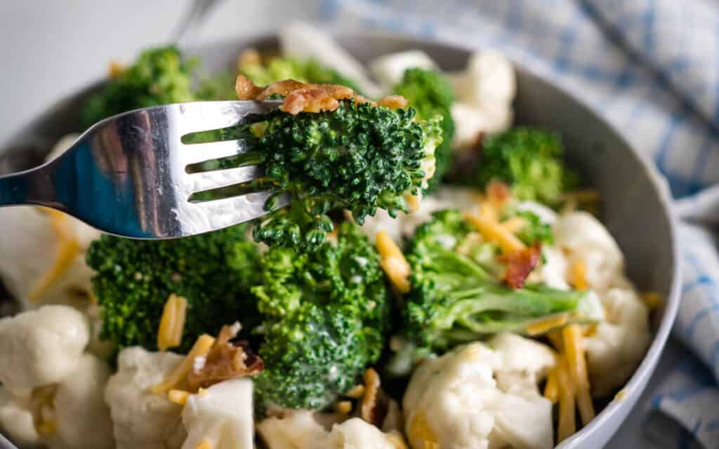 Amish broccoli salad with broccoli, cauliflower, cheese and bacon.