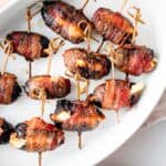 Bacon Wrapped Dates in a casserole dish.