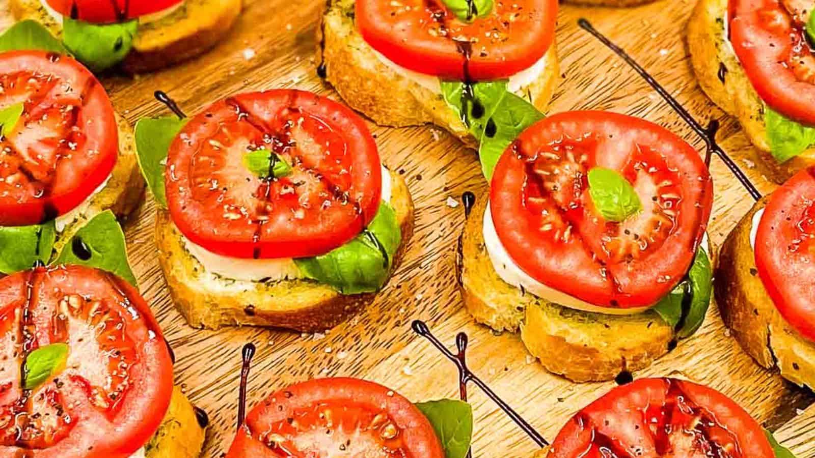 Image shows an overhead shot of Caprese Bites on a wooden board.