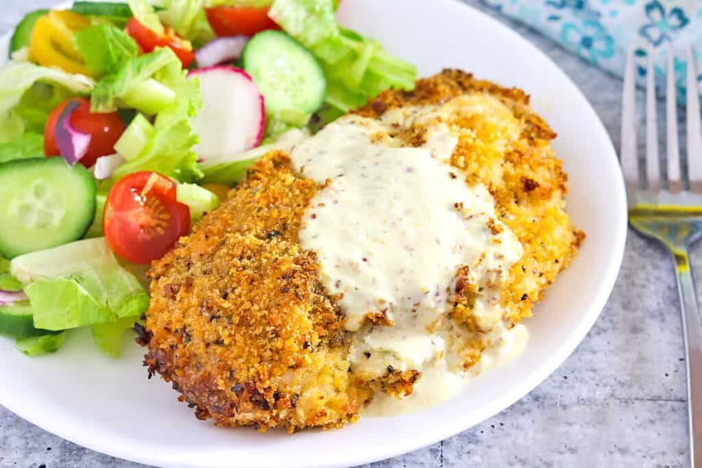 Air Fryer Chicken Cordon Bleu on a white plate with House Salad