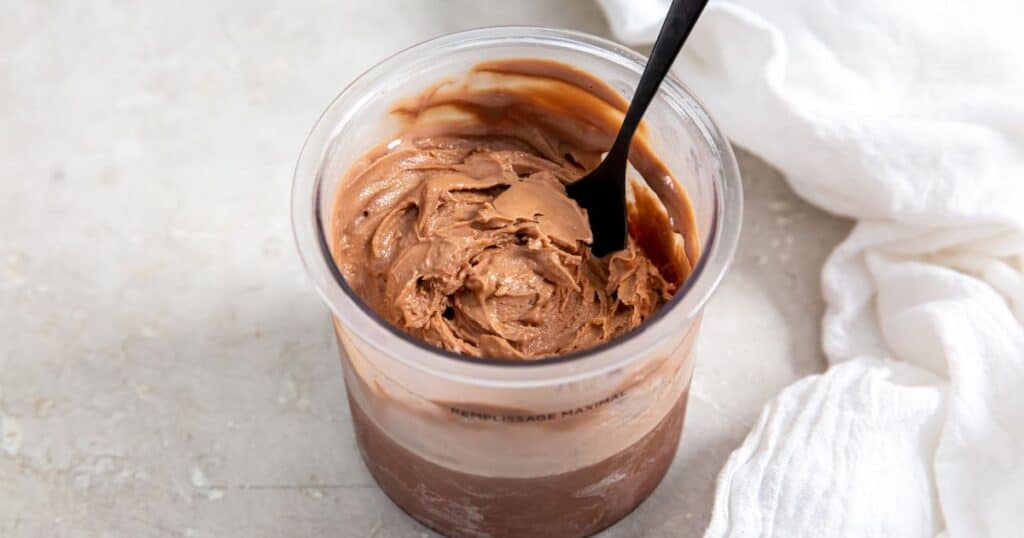 chocolate protein ice cream without bananas in a pint with a spoon.