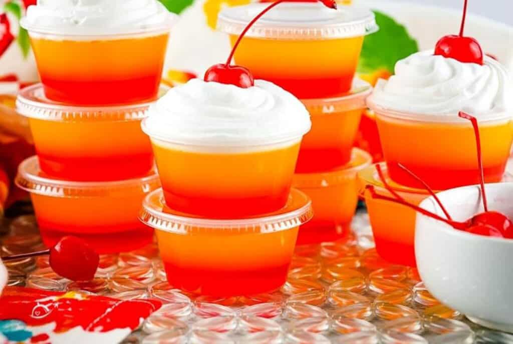 A red and orange layered jello shot.