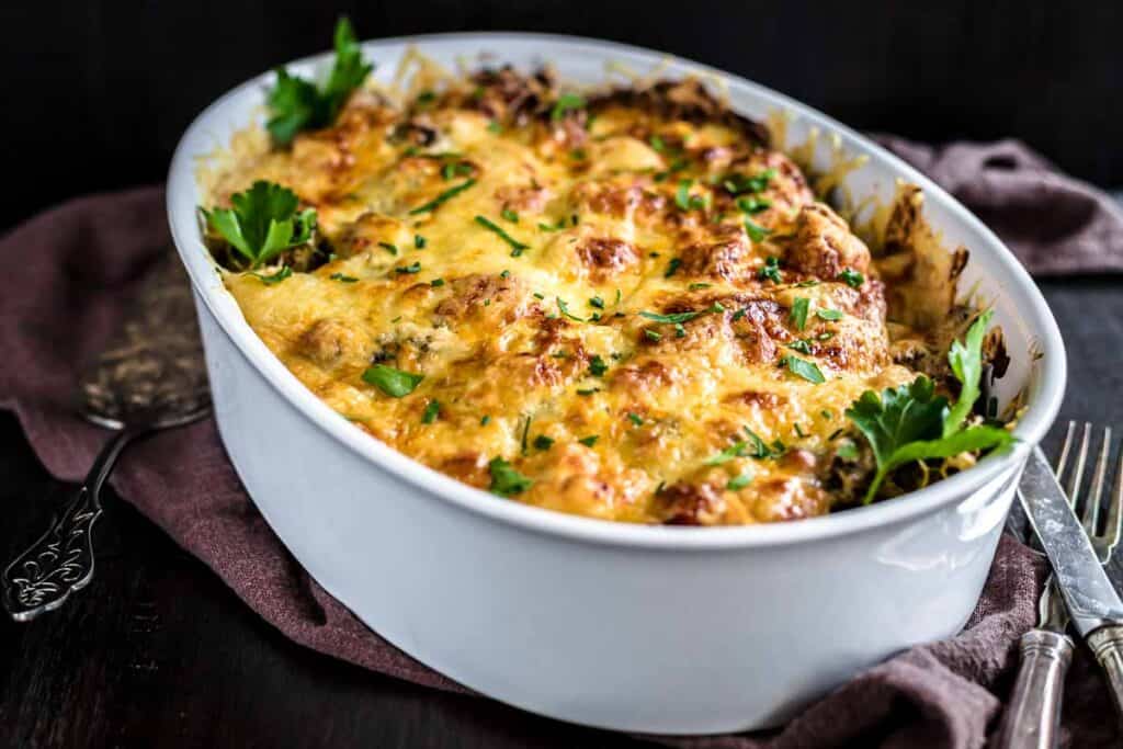 Cheesy Crack Chicken Casserole with Bacon inside a white dish.