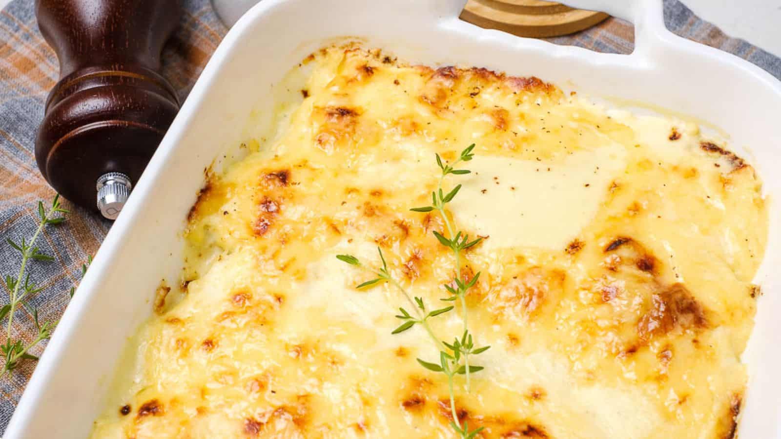An oven dish with baked dauphinoise potatoes in it.