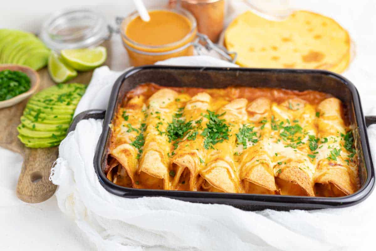 Casserole with rolled enchiladas filled with chicken. 