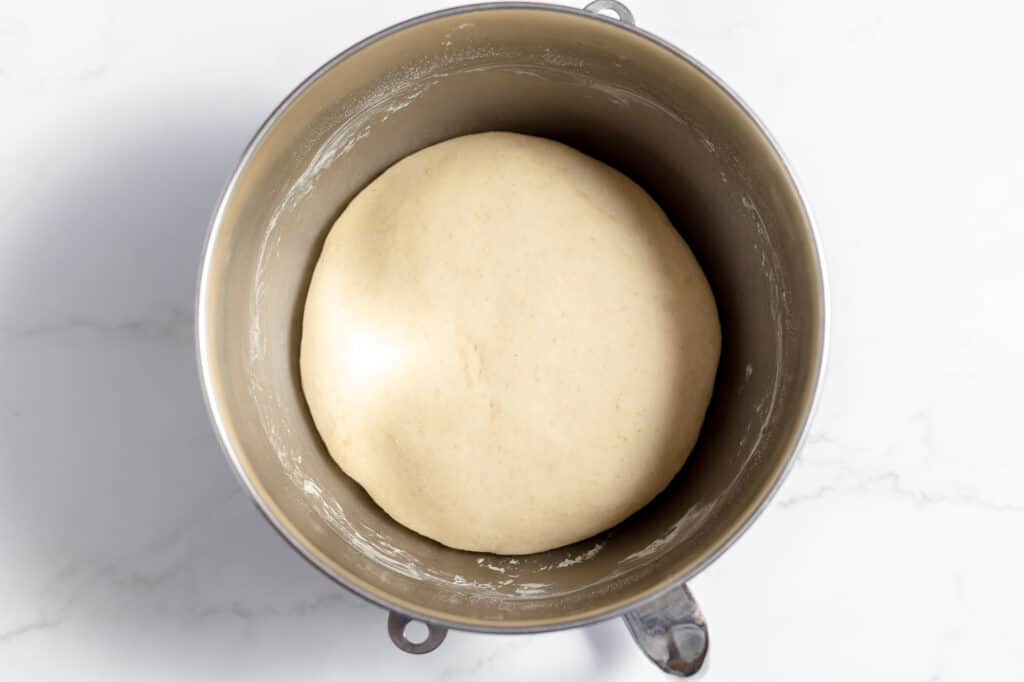 Proofed bread dough in a stand mixer bowl. 