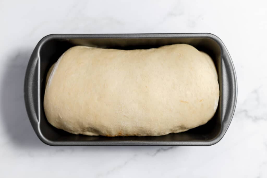 Bread dough in the prepared loaf pan.