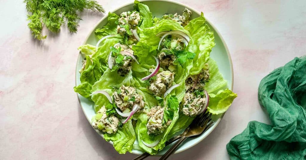 healthy tuna salad with no mayonnaise on a white plate with two forks.