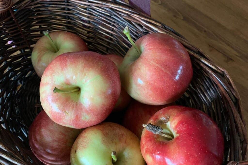 McIntosh apples in a wicker basket.