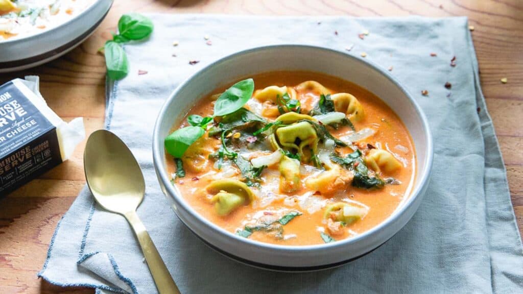 Creamy tomato tortellini soup made in the Instant Pot in a bowl.