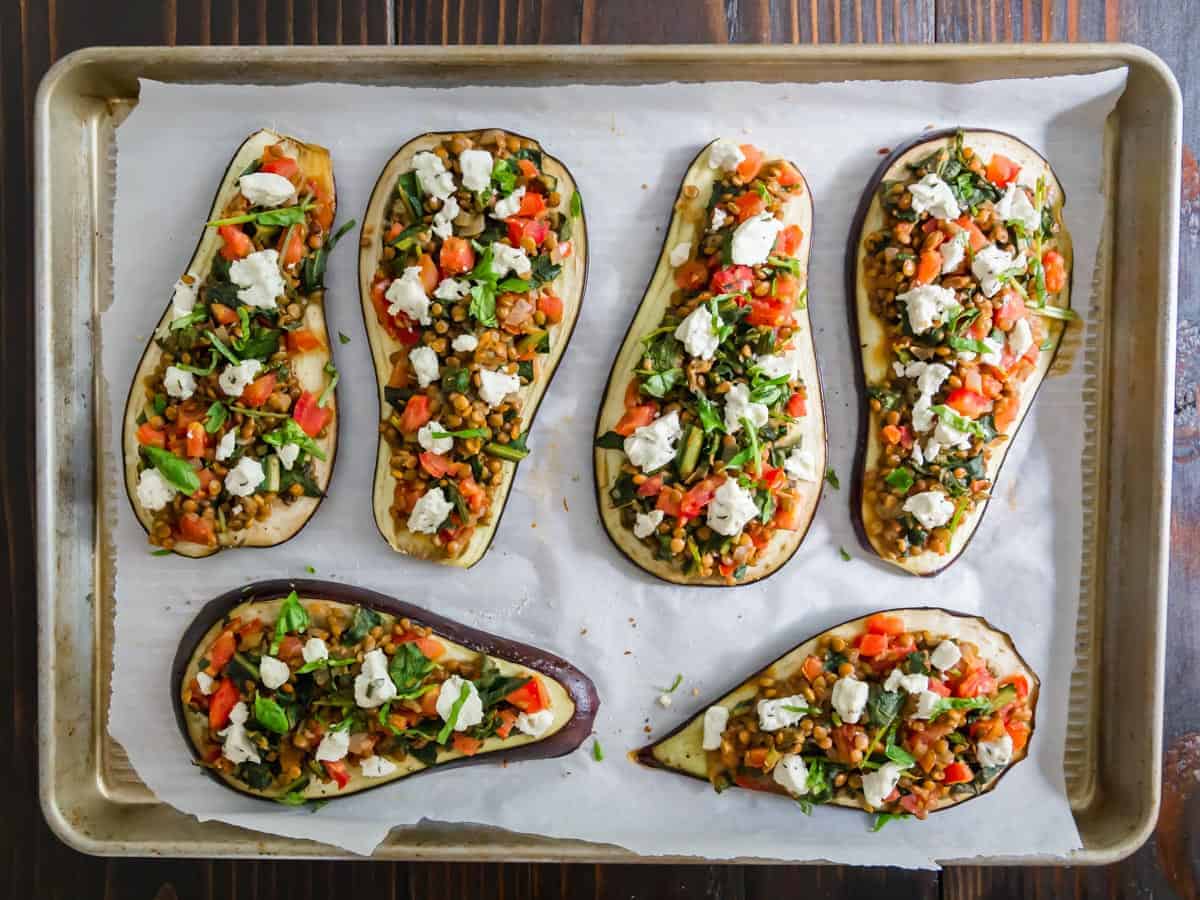 Eggplant slices on a baking sheet topped with lentil stuffing.