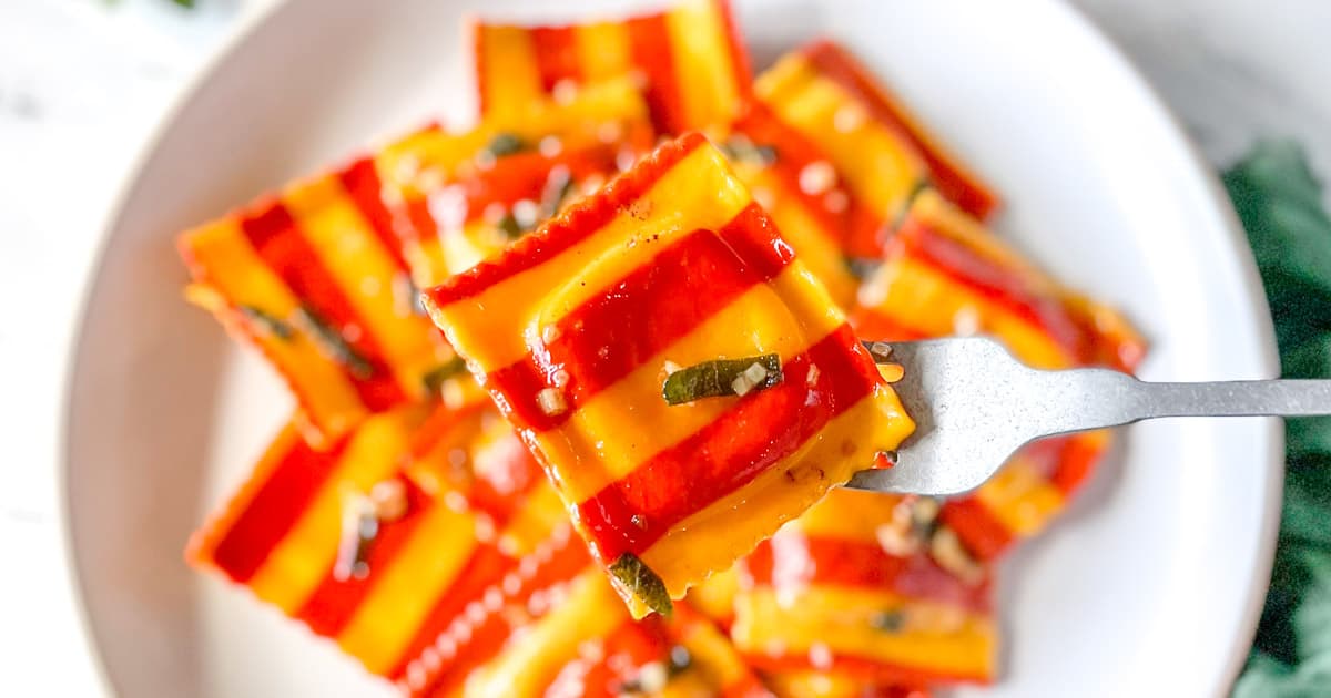 closeup of lobster ravioli on a silver fork.