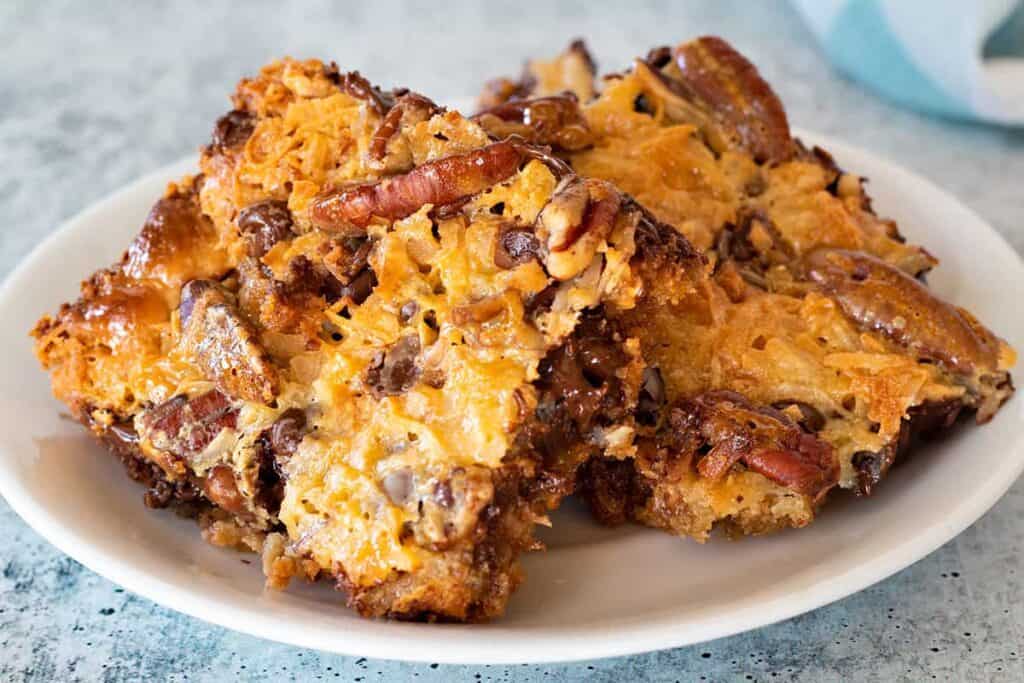 Magic cookie bars on a plate.