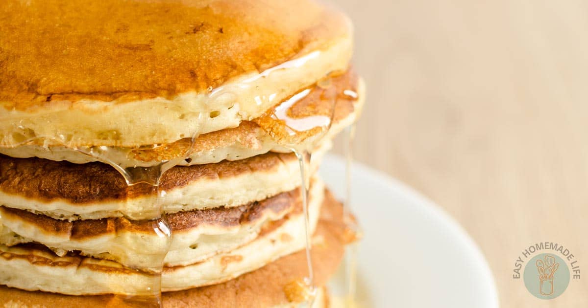A stack of McDonald’s Pancake Recipe with syrup drizzling down.