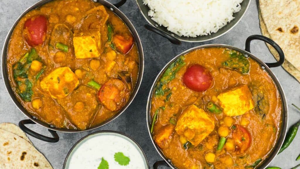 Two Balti dishes with paneer jalfrezi in them.