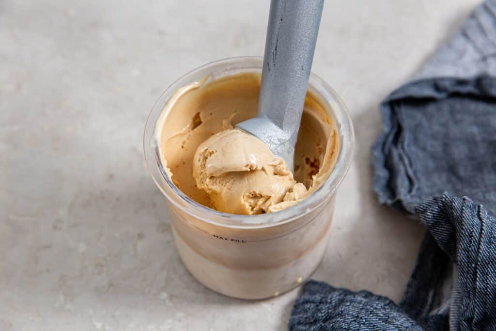 Ninja Creami Peanut Butter Ice cream in a pint with an ice cream scoop.
