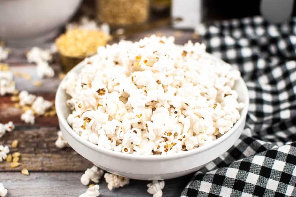 Air fryer popped popcorn in a white bowl.