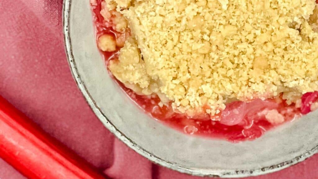 Rhubarb Crumble in a bowl on a red dishtowel.