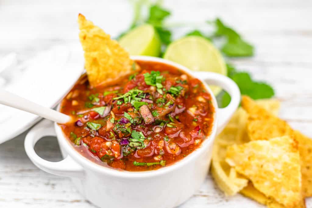 Keto salsa in a white ceramic bowl with handles.