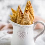 Sesame crackers in small pitcher.