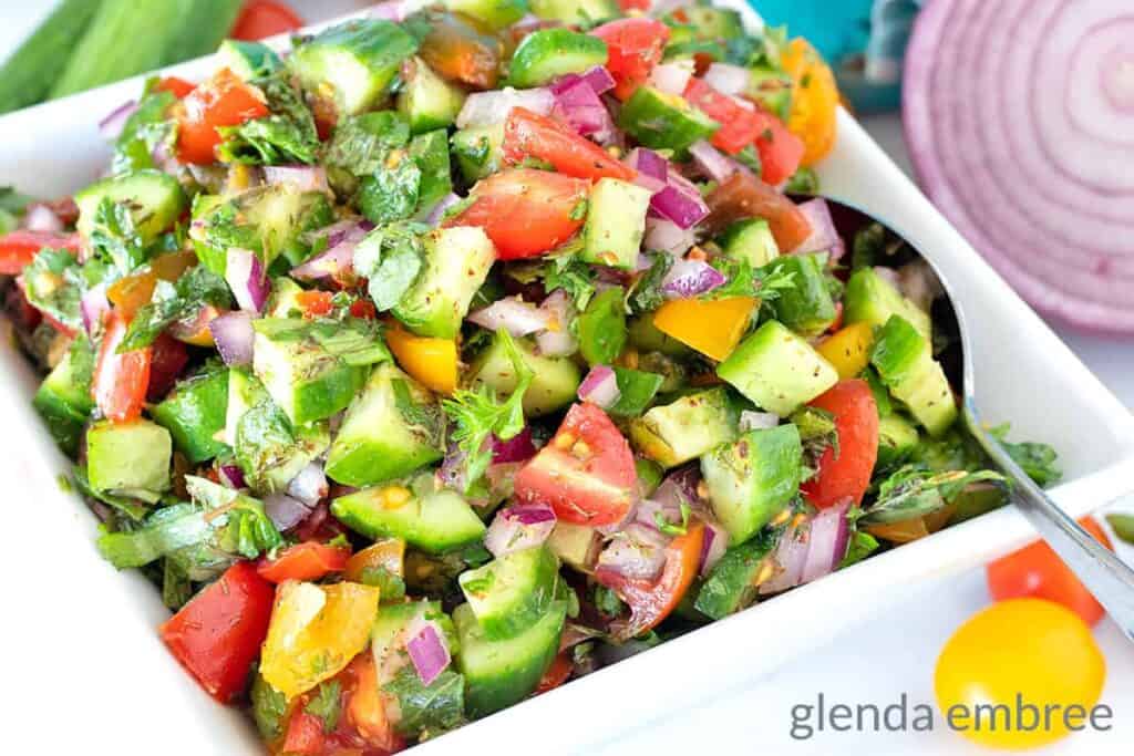 A colorful assortment of chopped veggies in a white bowl.