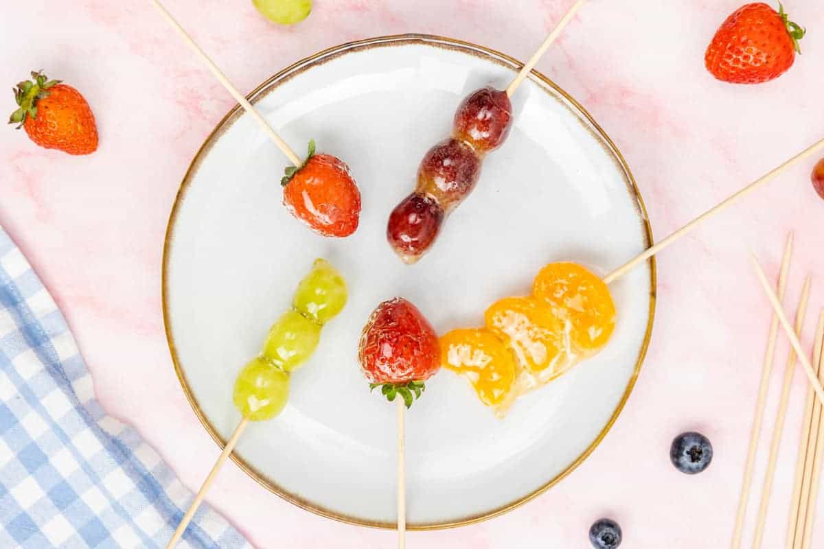 Tanghulu - skewers of coated grapes and oranges.