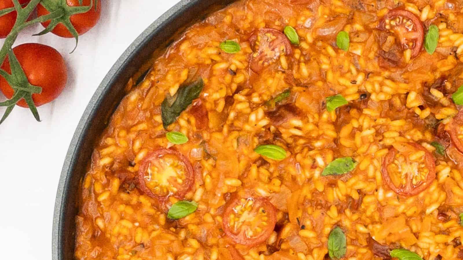 Risotto with tomatoes in a skillet.