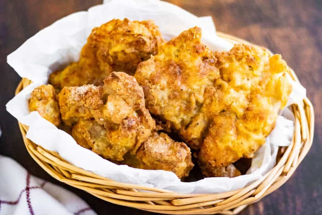 Air fryer fried chicken in a basket.