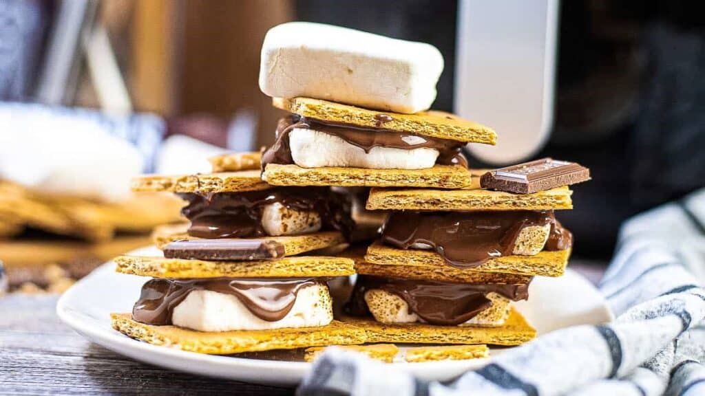 Air Fryer S'mores stacked in front of the air fryer.