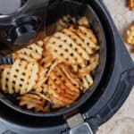 Air fryer with fries inside.