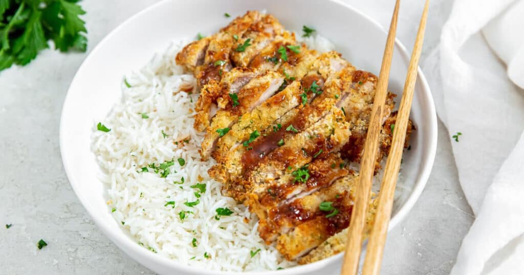 A bowl of white rice topped with air fryer chicken katsu.