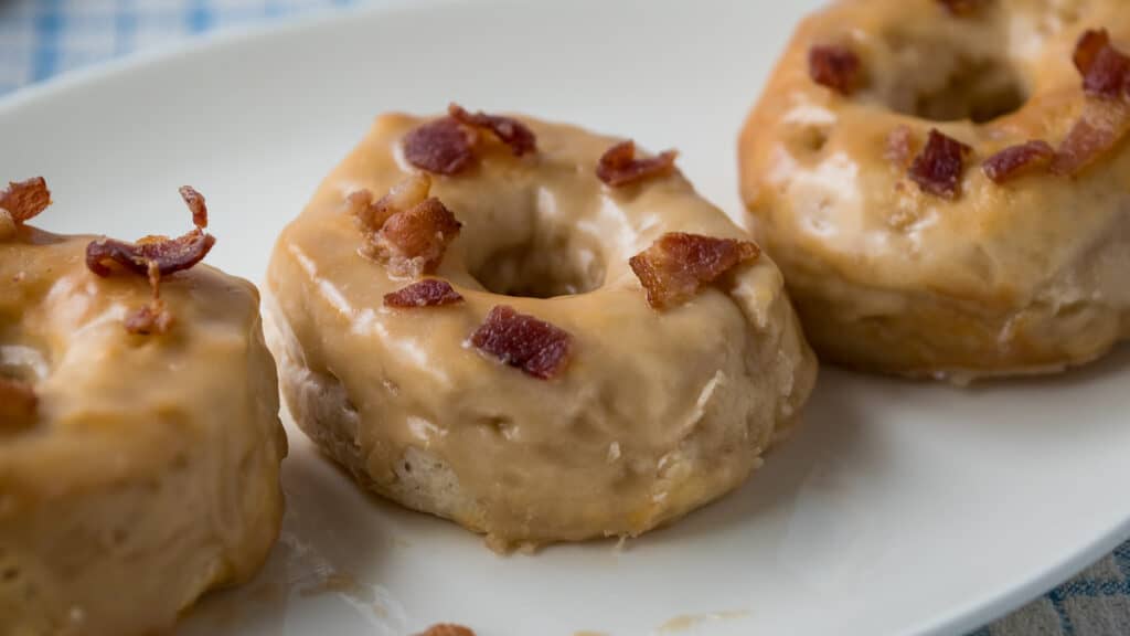 Air Fryer Maple Donuts with bacon on top.