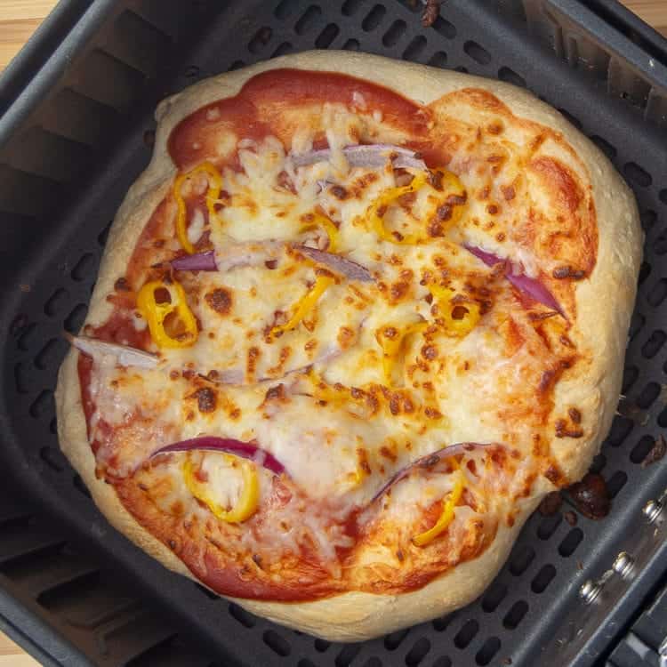 Pizza in basket of the air fryer.