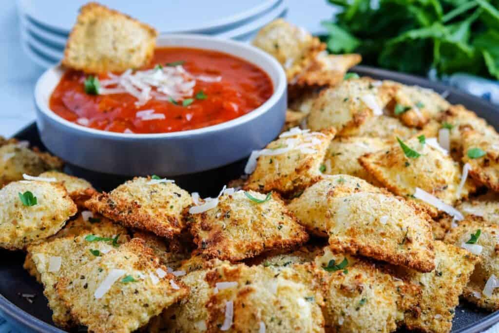 Air fryer ravioli with red sauce dip.