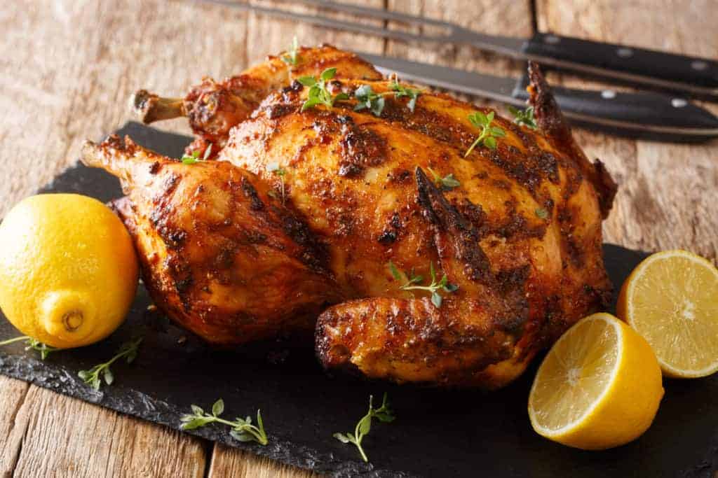 Roasted whole chicken with lemons.