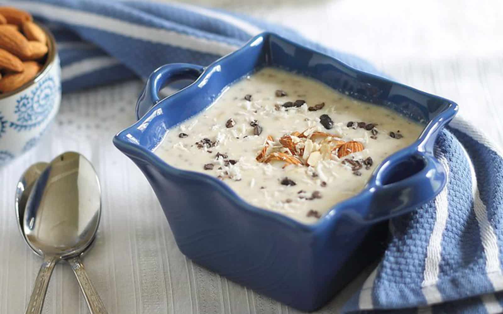 Overnight almond joy oats with chocolate chips, coconut and almonds in a blue bowl.