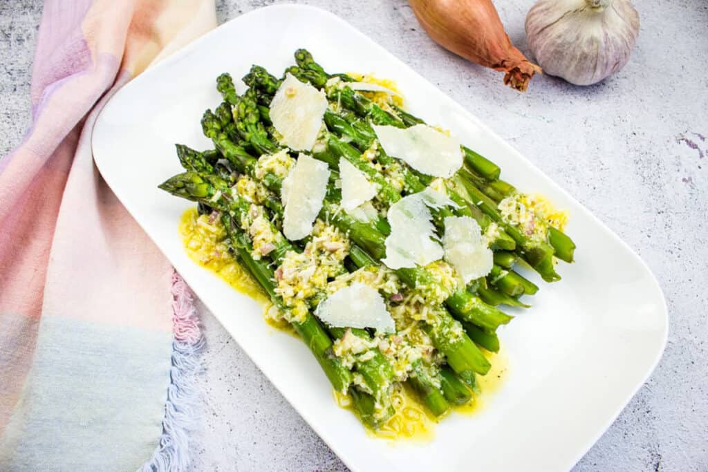 Asparagus with Lemon and Parmesan on a white platter.