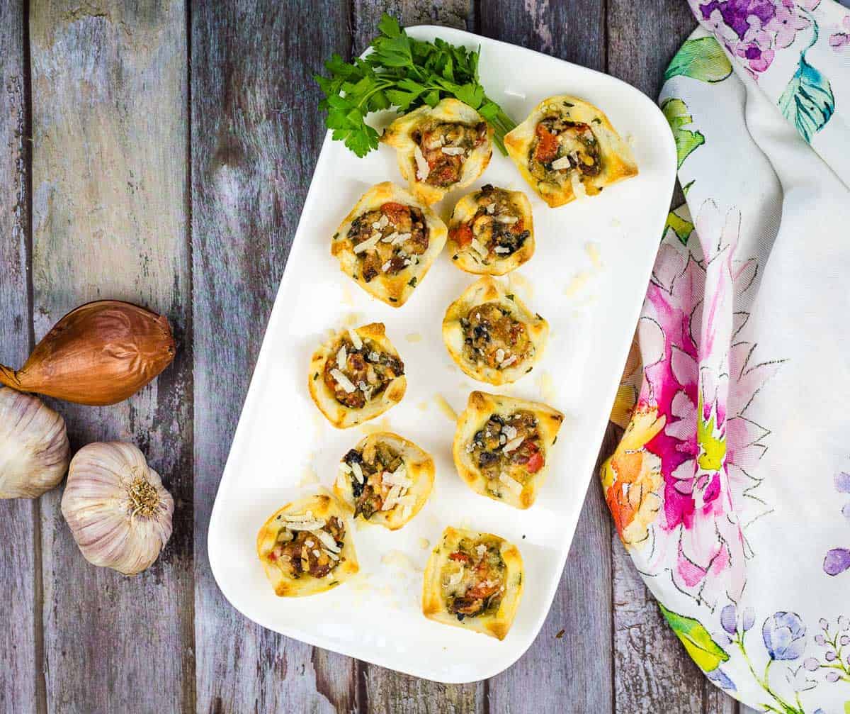 Bacon & Mushroom Tartlets as appetizers on a plate.