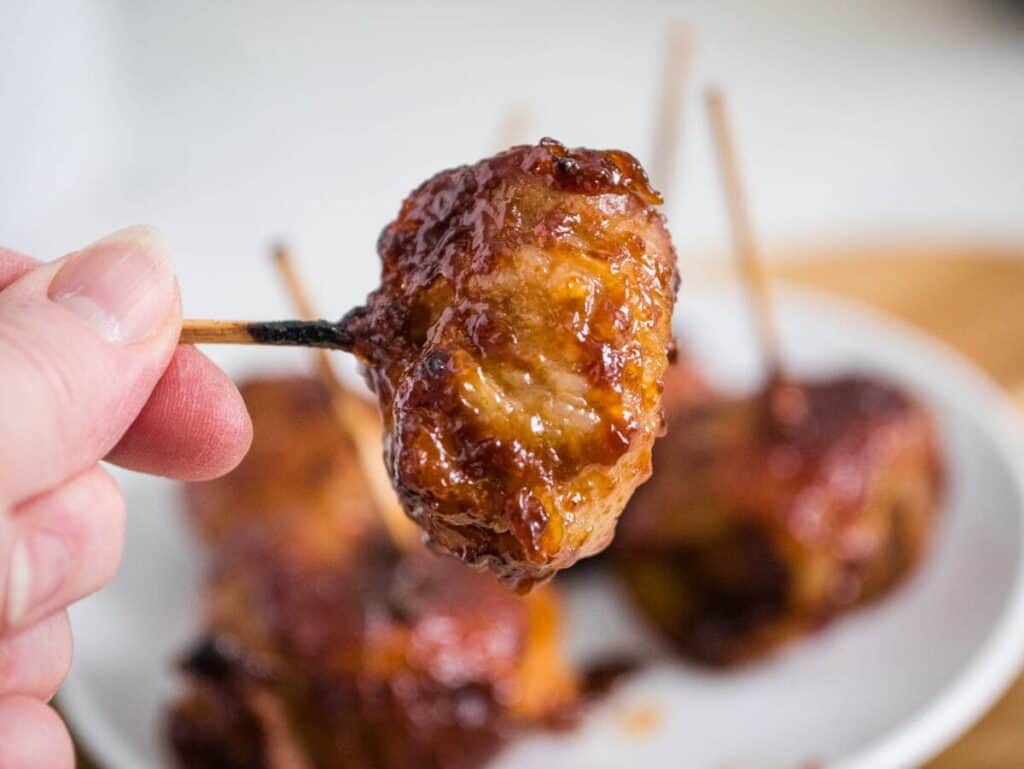 Bite size chestnuts wrapped in bacon on a toothpick.