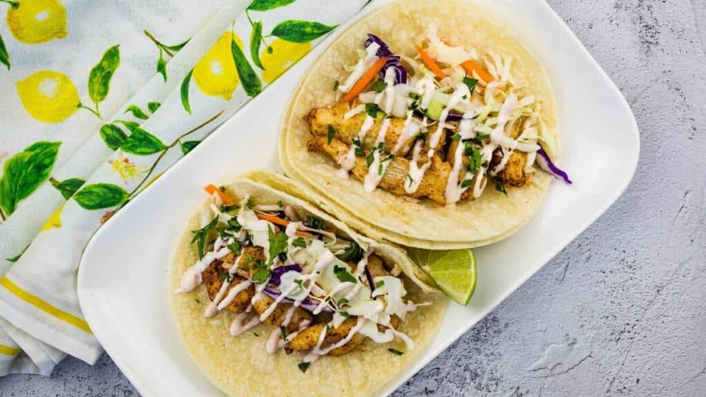 Baja fish tacos on a white plate.