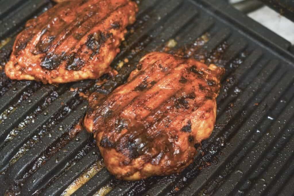 BBQ boneless chicken thighs on indoor grill.