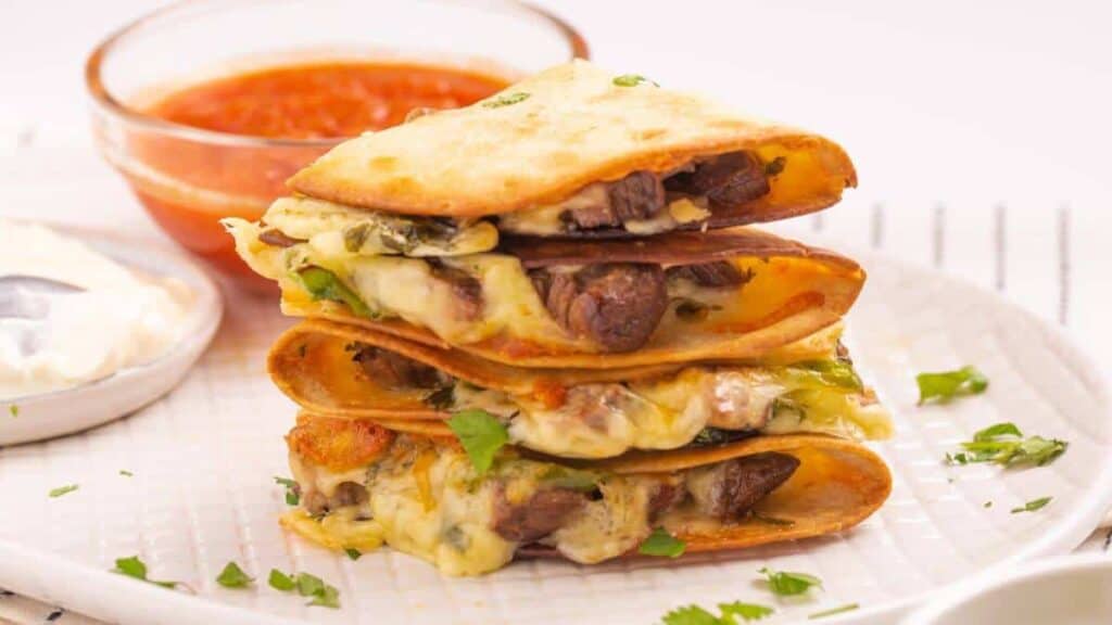 Stack of beef quesadillas on a plate.
