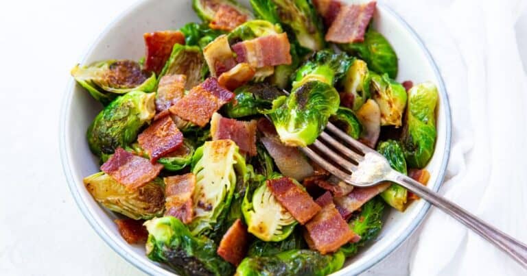 blackstone brussel sprouts with bacon in a bowl with a fork