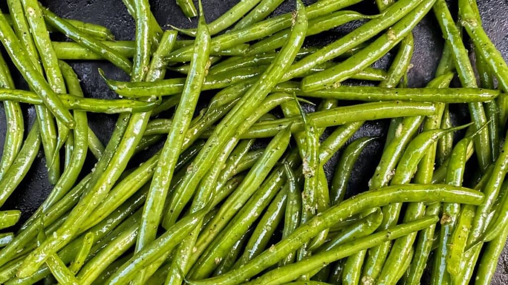 green beans cooking on a blackstone grill